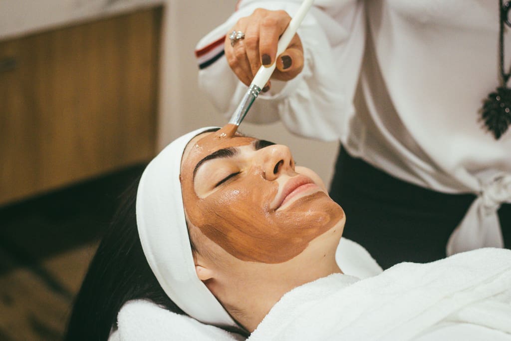 A guest receiving a clay facial treatment at Solara