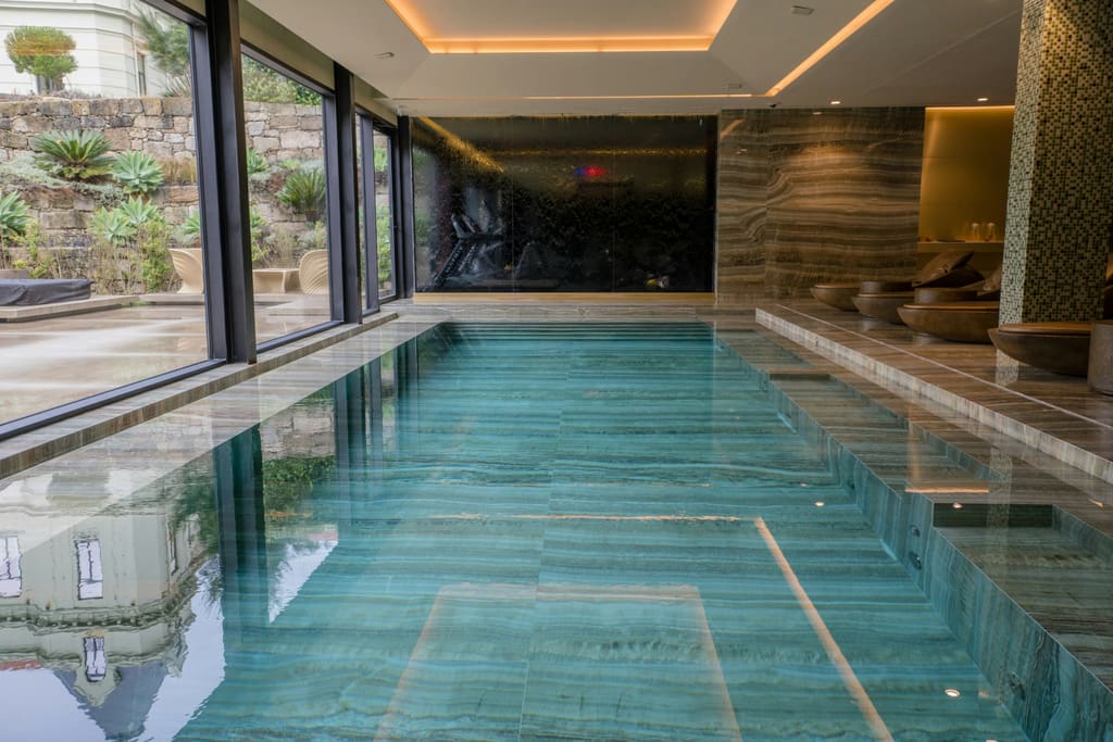 The serene indoor onyx pool at Solara