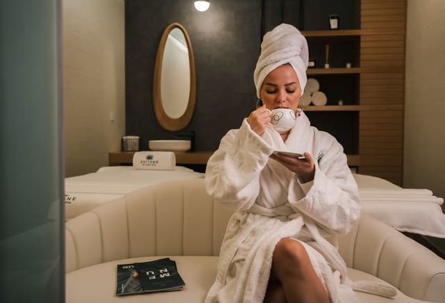 A guest relaxing with tea in a robe at Solara